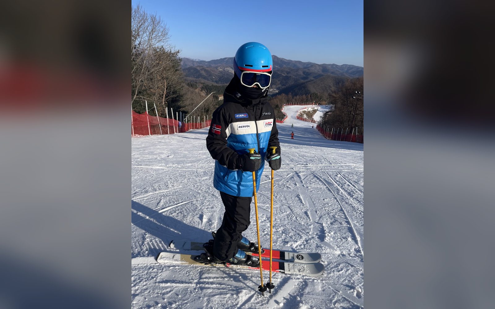 파란 헬멧을 쓰고 슬로프에 선 아이